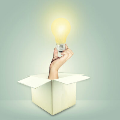 Hand coming out of a box with a lightbulb - ADHD Treatment for Adults in CA